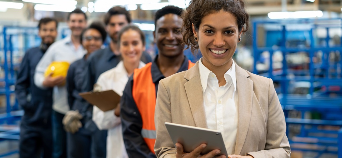 diverse team standing in diagonal line in a warehouse