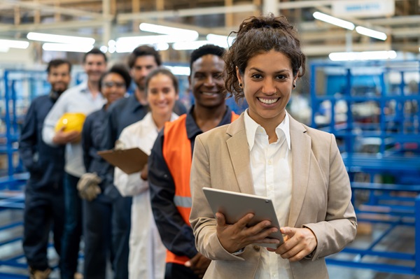diverse team standing in diagonal line in a warehouse