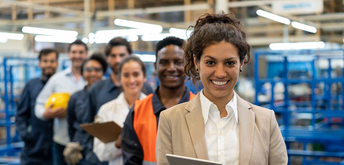 diverse team standing in diagonal line in a warehouse