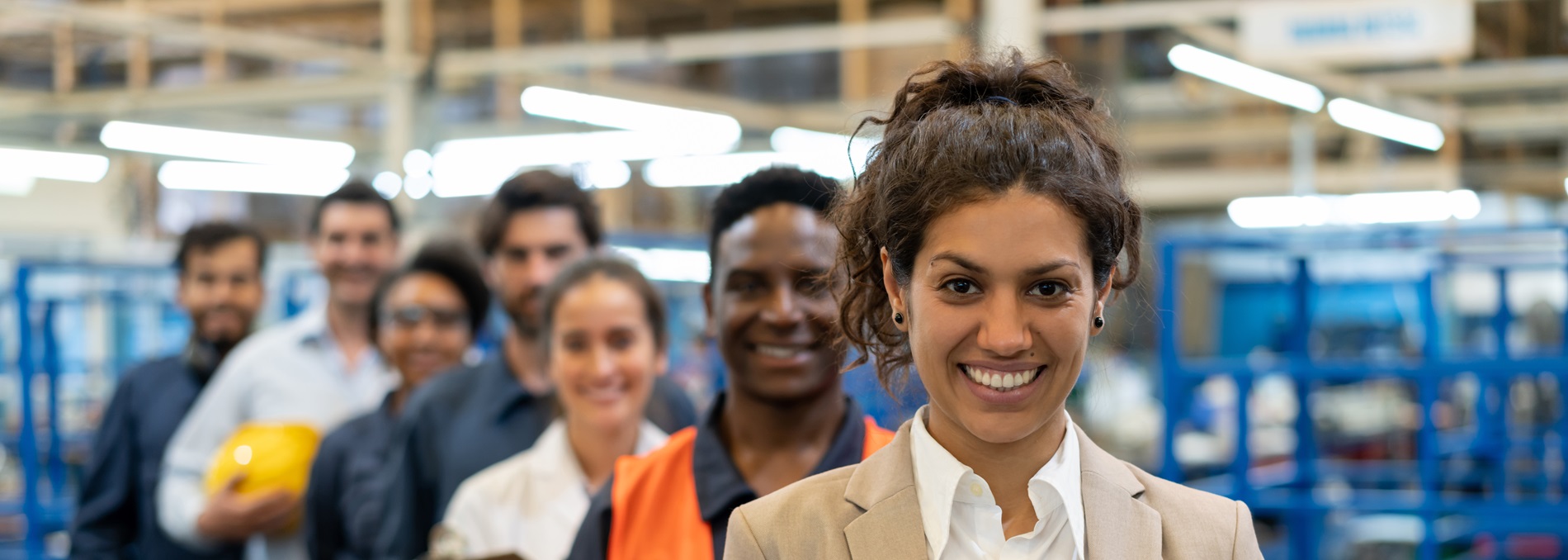diverse team standing in diagonal line in a warehouse