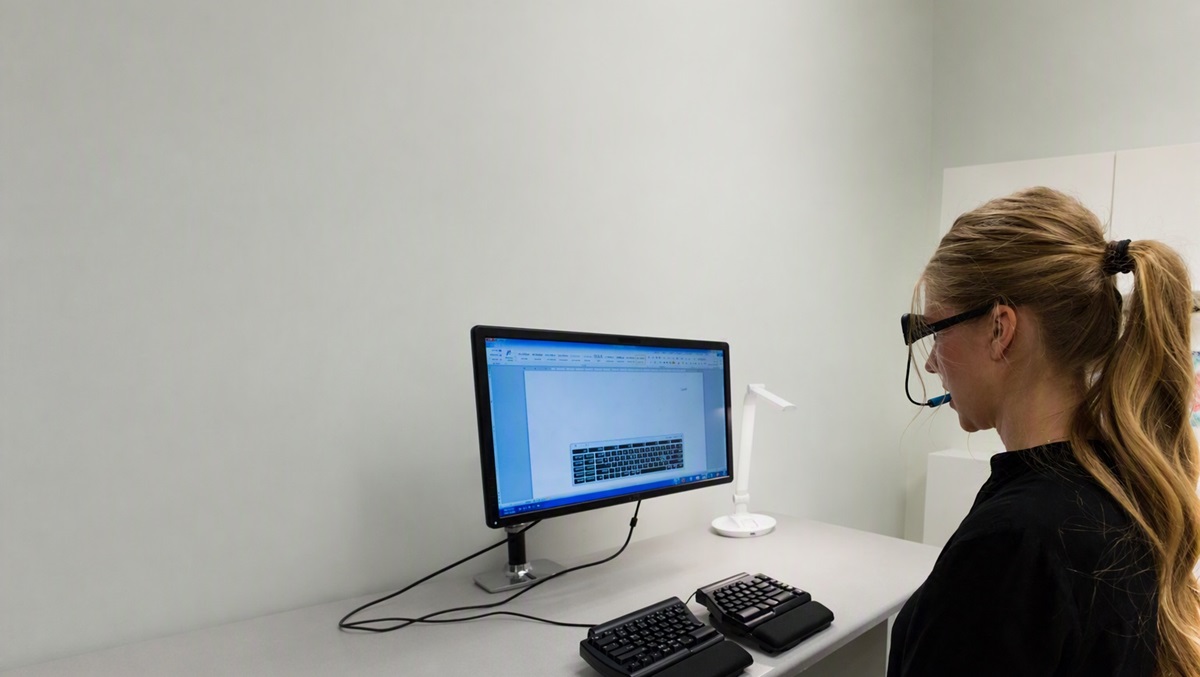 Young female using assistive technology to use her computer
