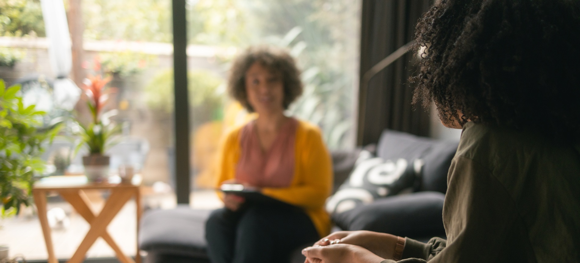 two woman talking in casual space