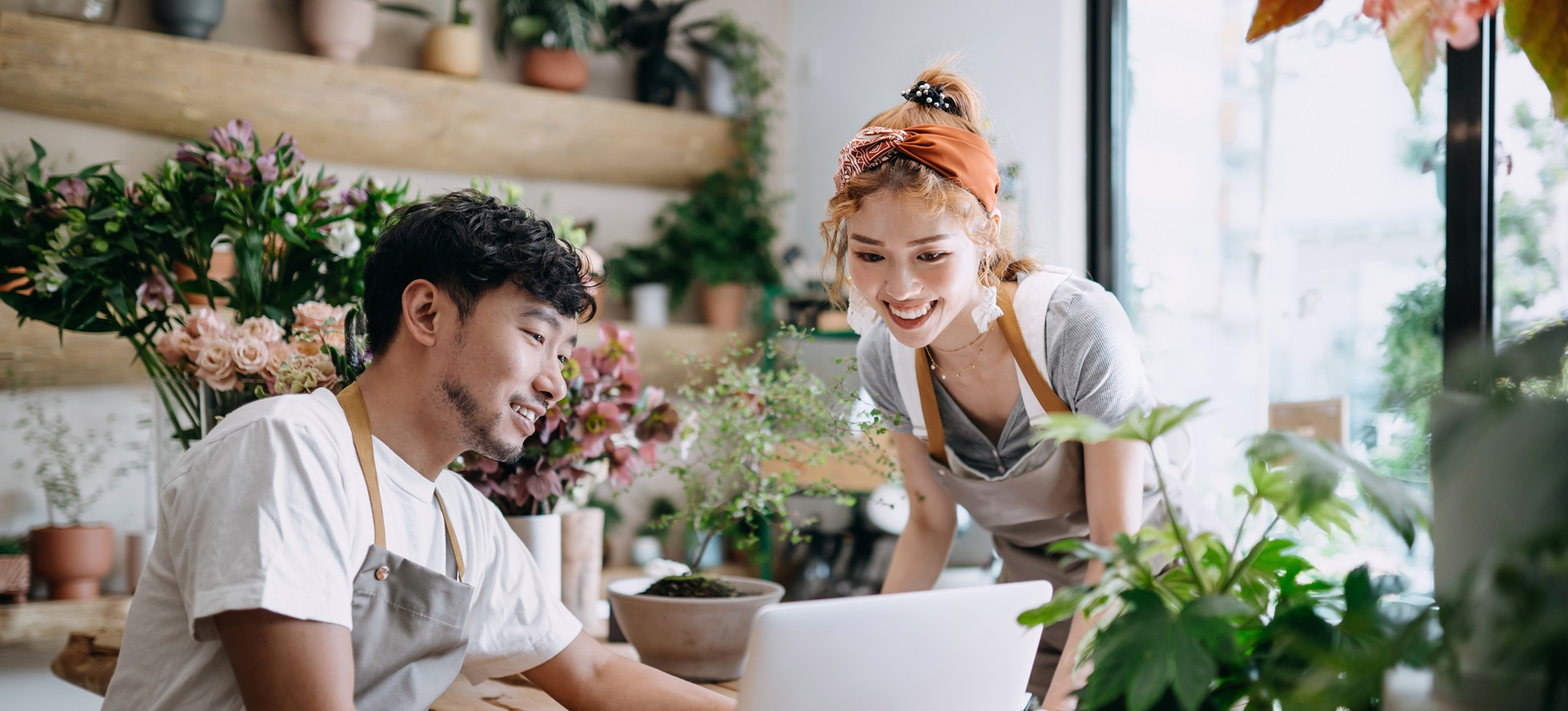 Two Asian colleagues working in a floral shop