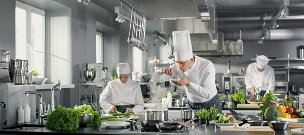 Chef and his team in the kitchen preparing a meal service