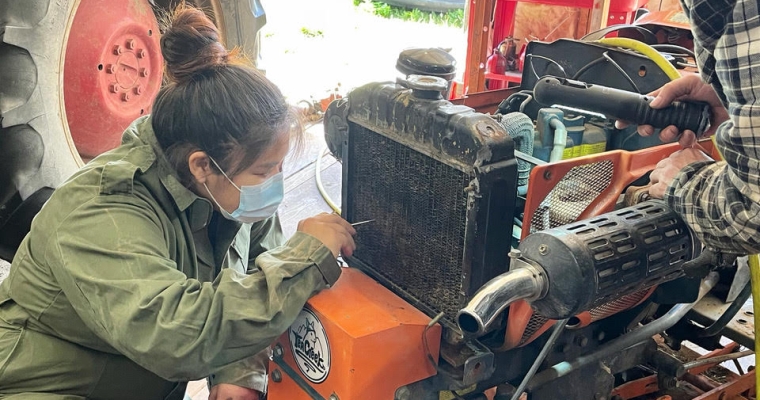 Julia working on a tractor