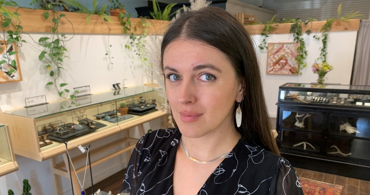 Jenny stands in the shop she now works at.