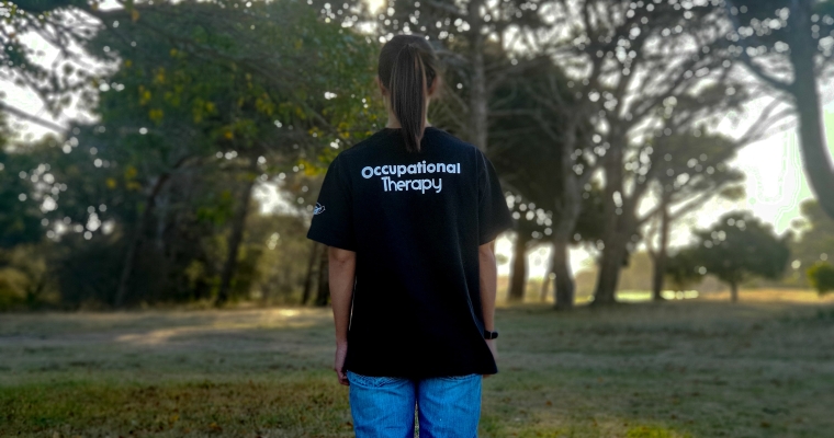 person wearing t-shirt that says occupational therapy