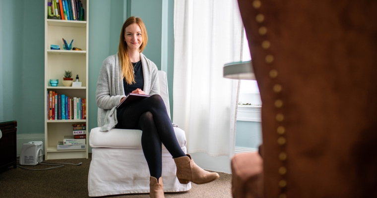 Female social worker sitting in front of a lounge chair