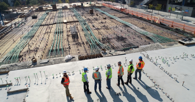 Group of six construction workers overlooking a site