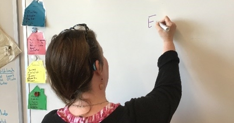 A women writing on the board
