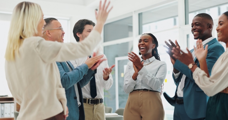 group of diverse employees smiling and clapping