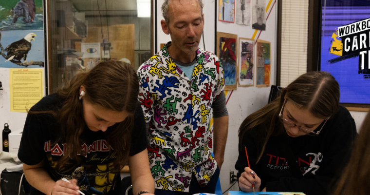 Secondary school art teacher Perry Rath instructing students in his classroom. On the right side of the image is WorkBC's Career Trek logo.