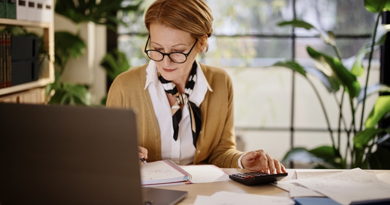 mature businesswoman calculating finances