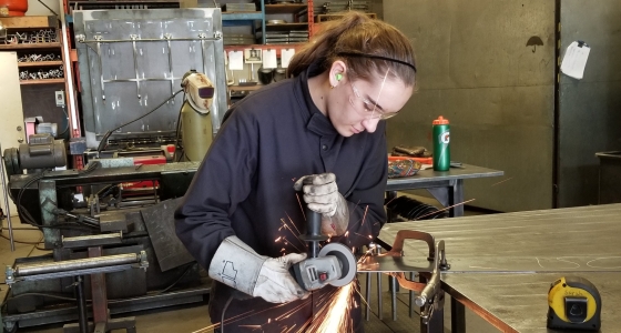 Sarah Dmytruk welding in a shop