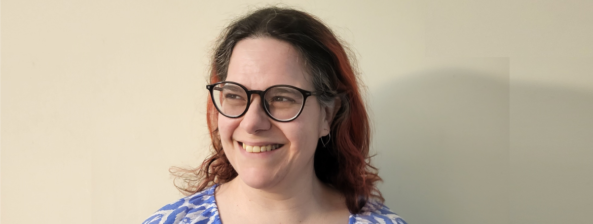 Alexandra, a woman with dark hair and glasses.