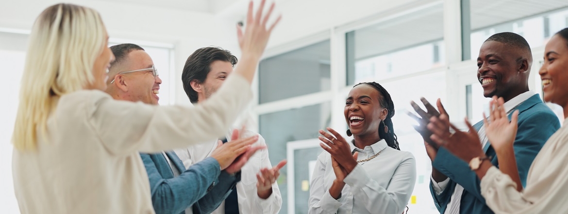 group of diverse employees smiling and clapping