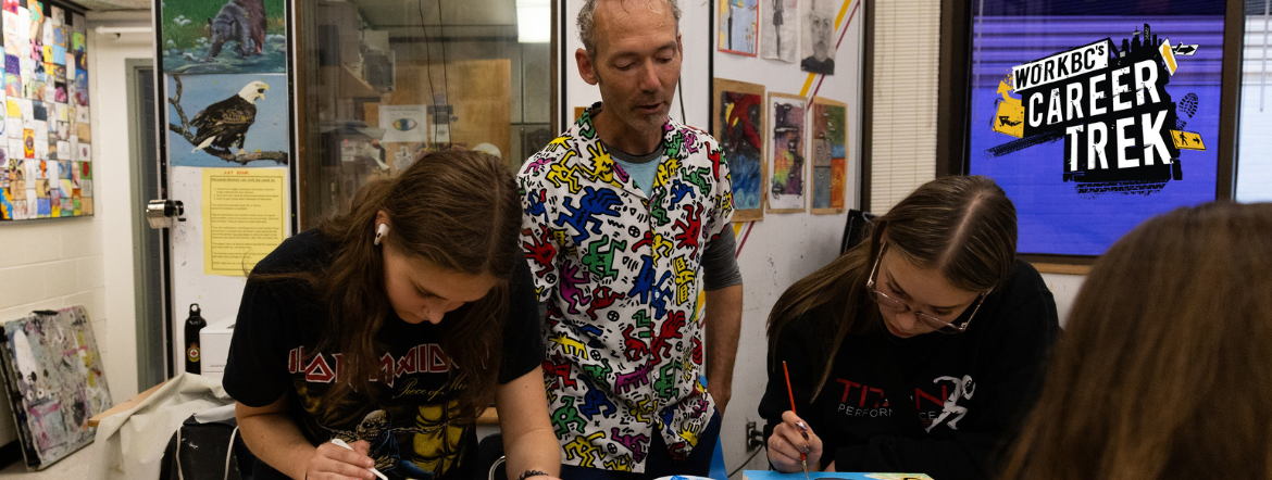 Secondary school art teacher Perry Rath instructing students in his classroom. On the right side of the image is WorkBC's Career Trek logo.