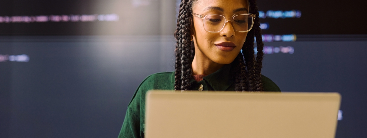 Black woman looking at a laptop