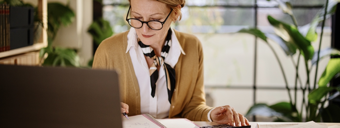 mature businesswoman calculating finances