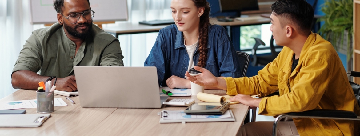 Diverse team talking at meeting