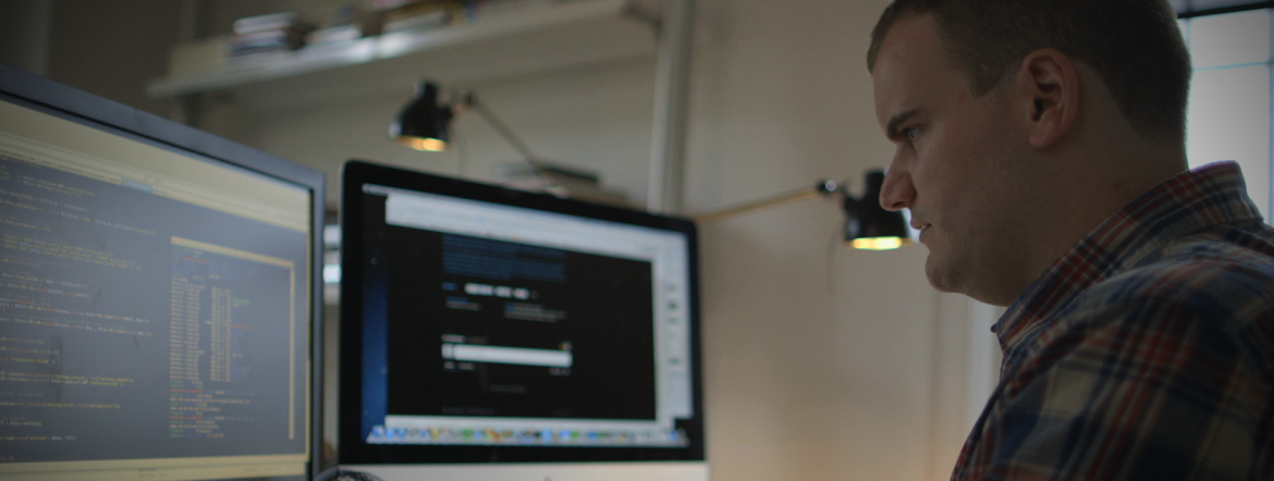 man coding at a computer