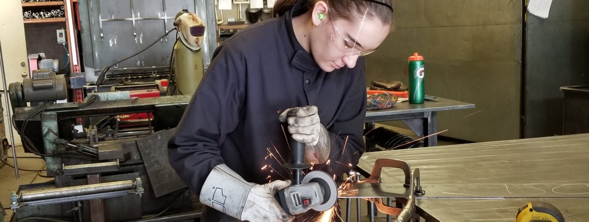 Sarah Dmytruk welding in a shop