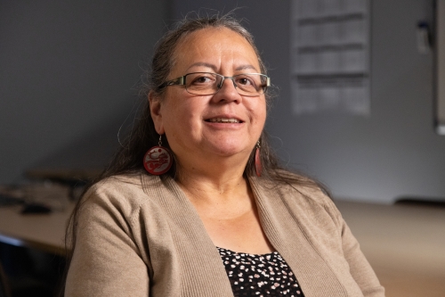 Ruby smiling at the camera in her office.