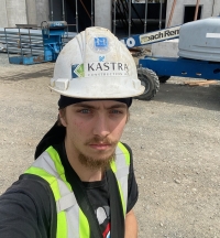 Young male wearing safety gear on construction site