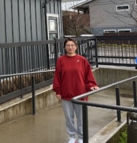 Woman wearing red sweater standing on ramp