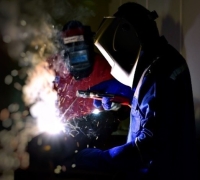 Two welders working and wearing safety gear