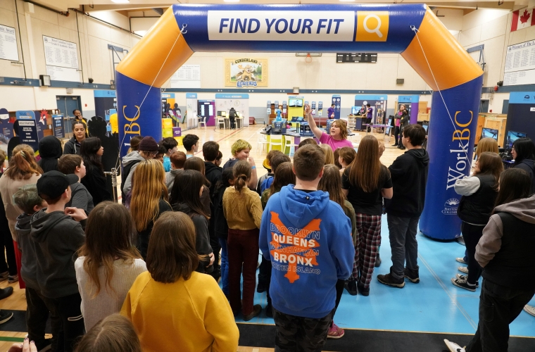 group of students and staff at a Find Your Fit event in a gymnasium