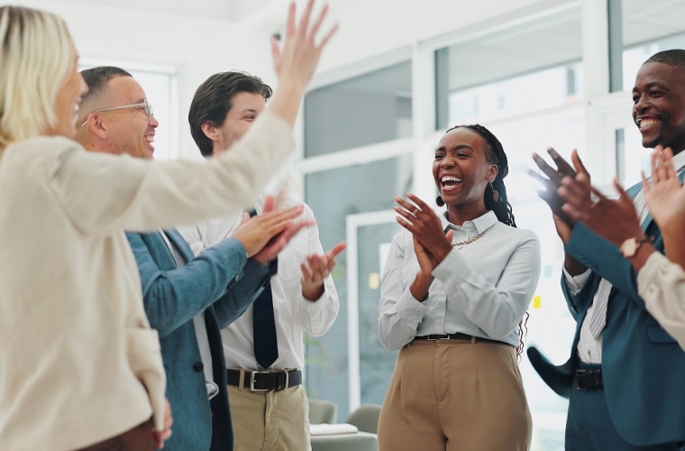 group of diverse employees smiling and clapping