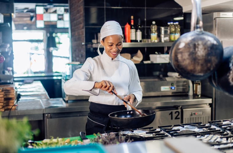 Female cook working in restaurant