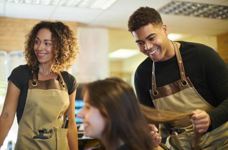 Male hairdresser with female teacher and client