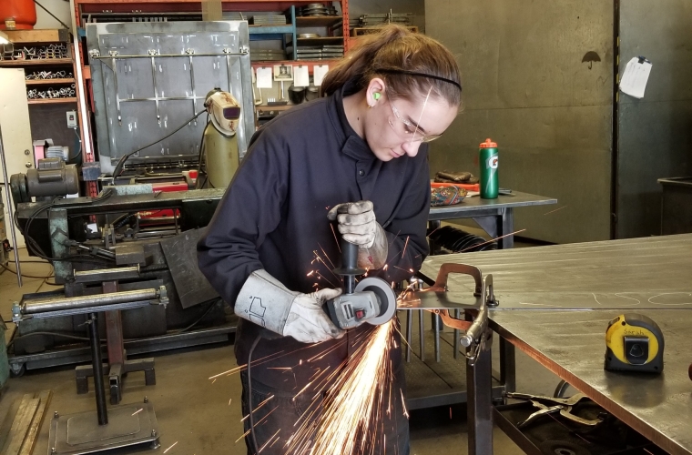 Sarah Dmytruk welding in a shop