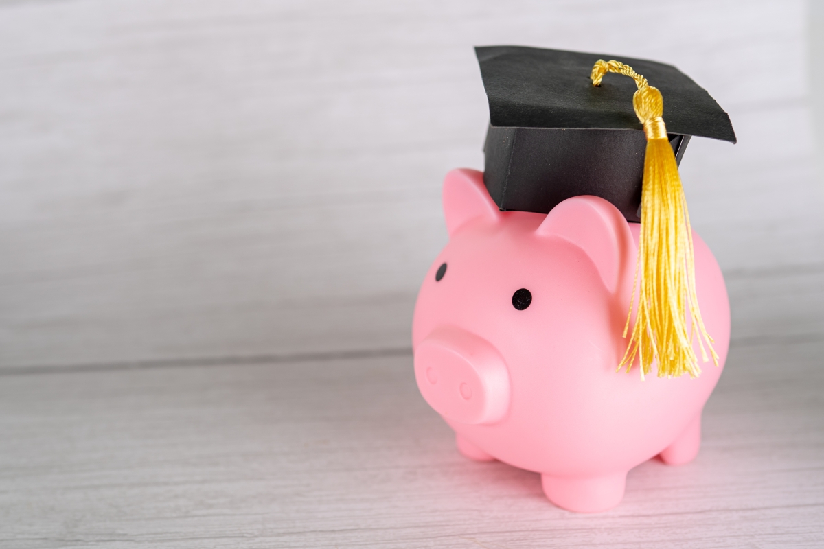 pink piggy bank wearing a graduation cap