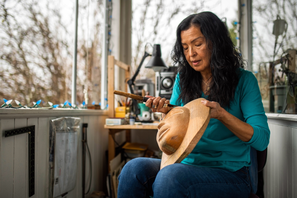 female Indigenous artist carving traditional art