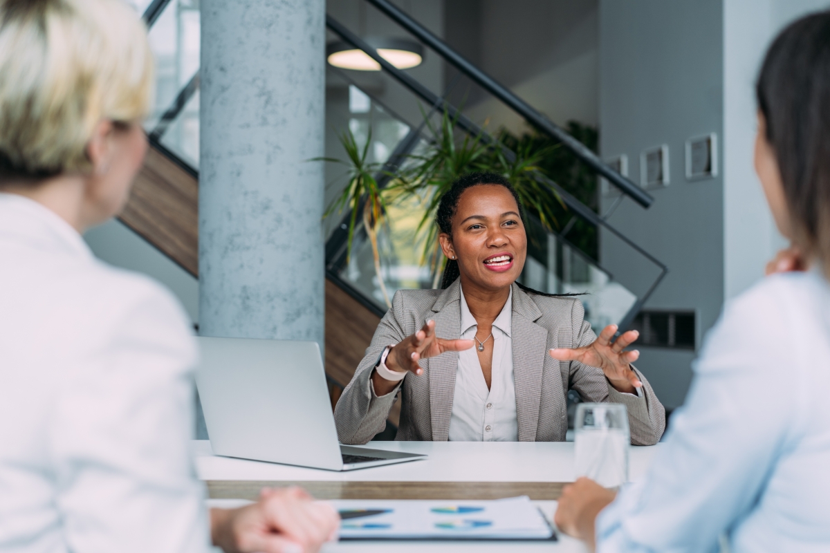 Black female manager in a meeting with her colleagues. 