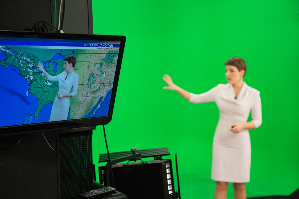 Female weather presenter explaining about weather forecast