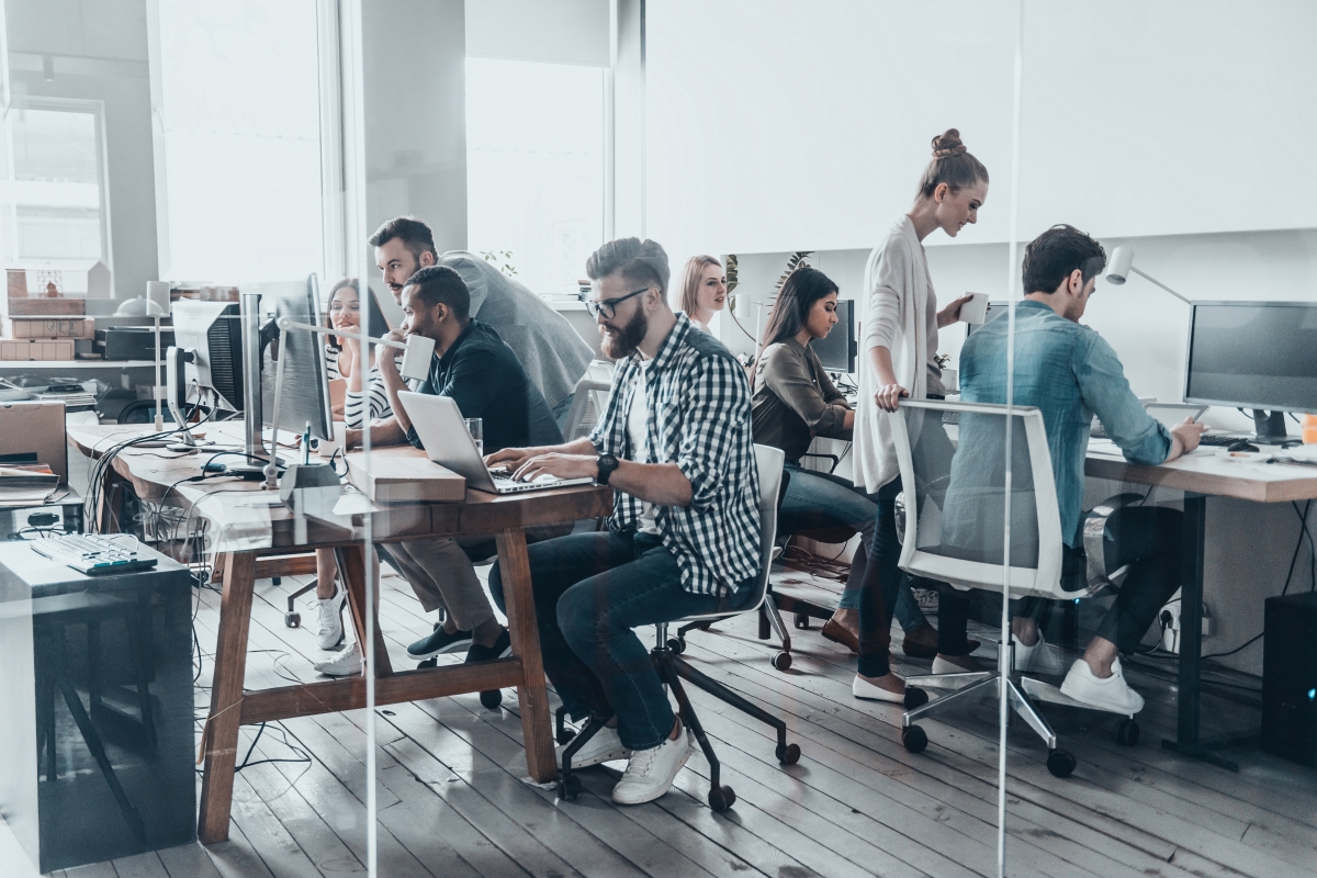 Group of young business people working on their computers together