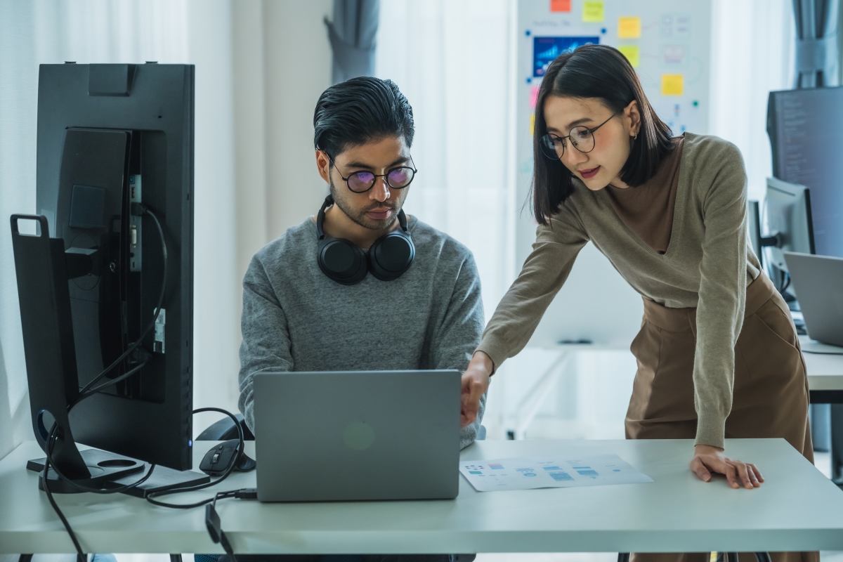 Asian and Indian analysts reviewing computer data