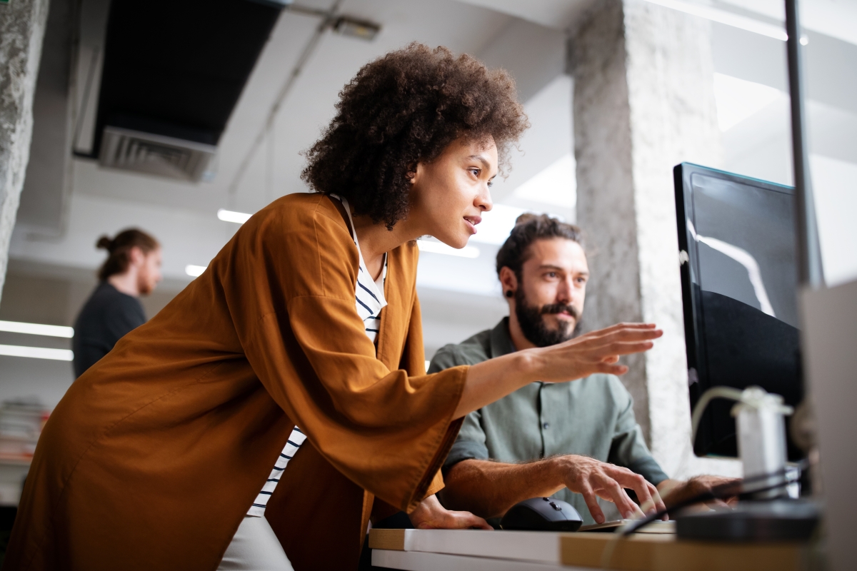Two web designers working collaboratively in office 