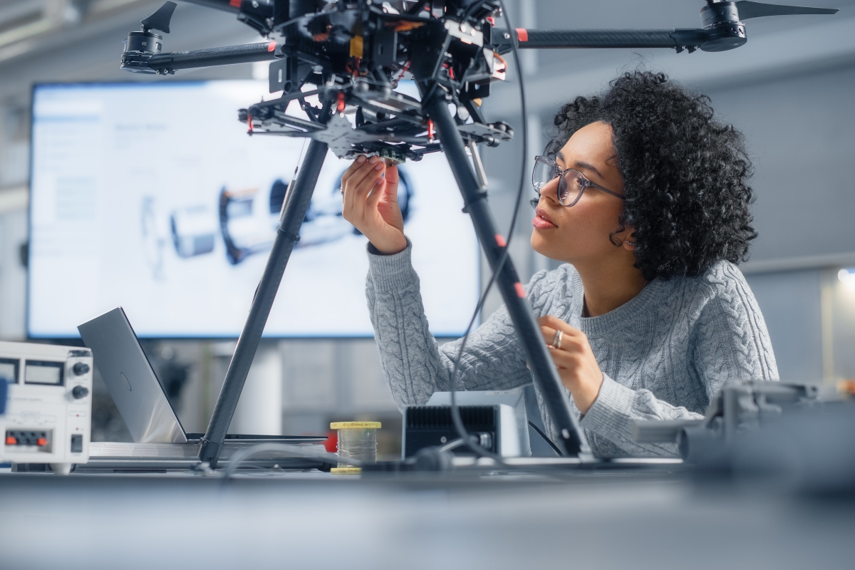 Young black female engineer working on a drone