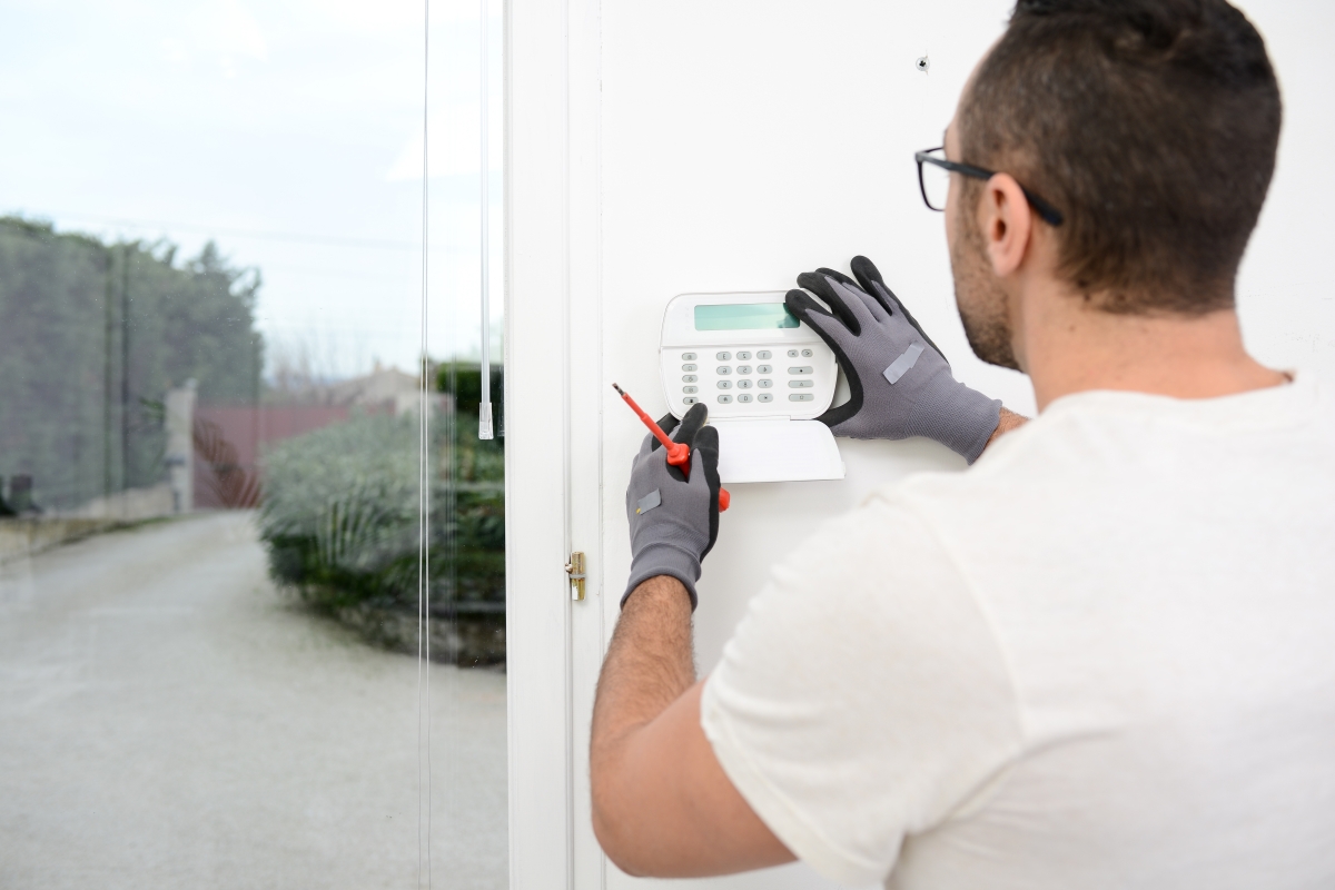 Male technician installing a home alarm system