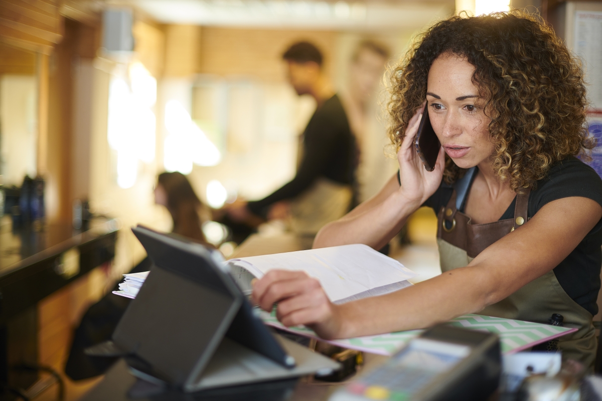 Female salon manager on phone