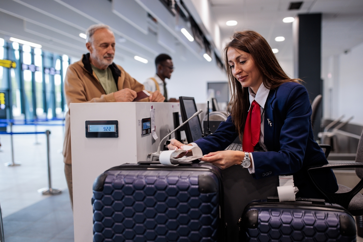Mature male at baggage check-in at airport.