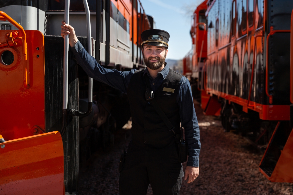 Male train conductor at a railway station.