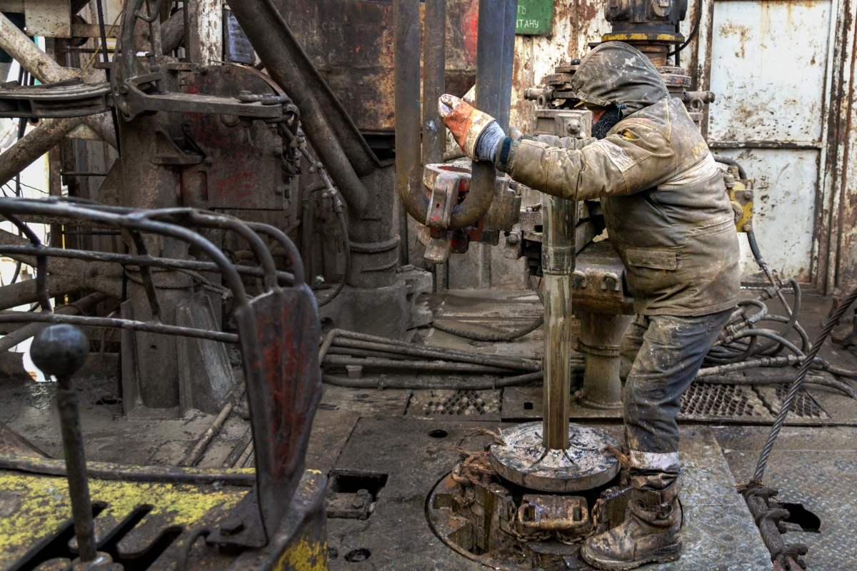 Offshore oil rig worker prepares tool and equipment for making a drill pipe connection.