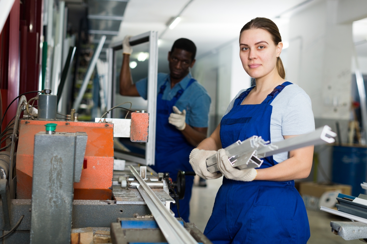 two people working on a plastics assembly line