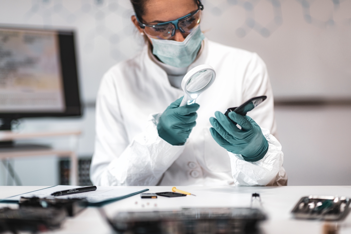 biologist examining something with a magnifying glass
